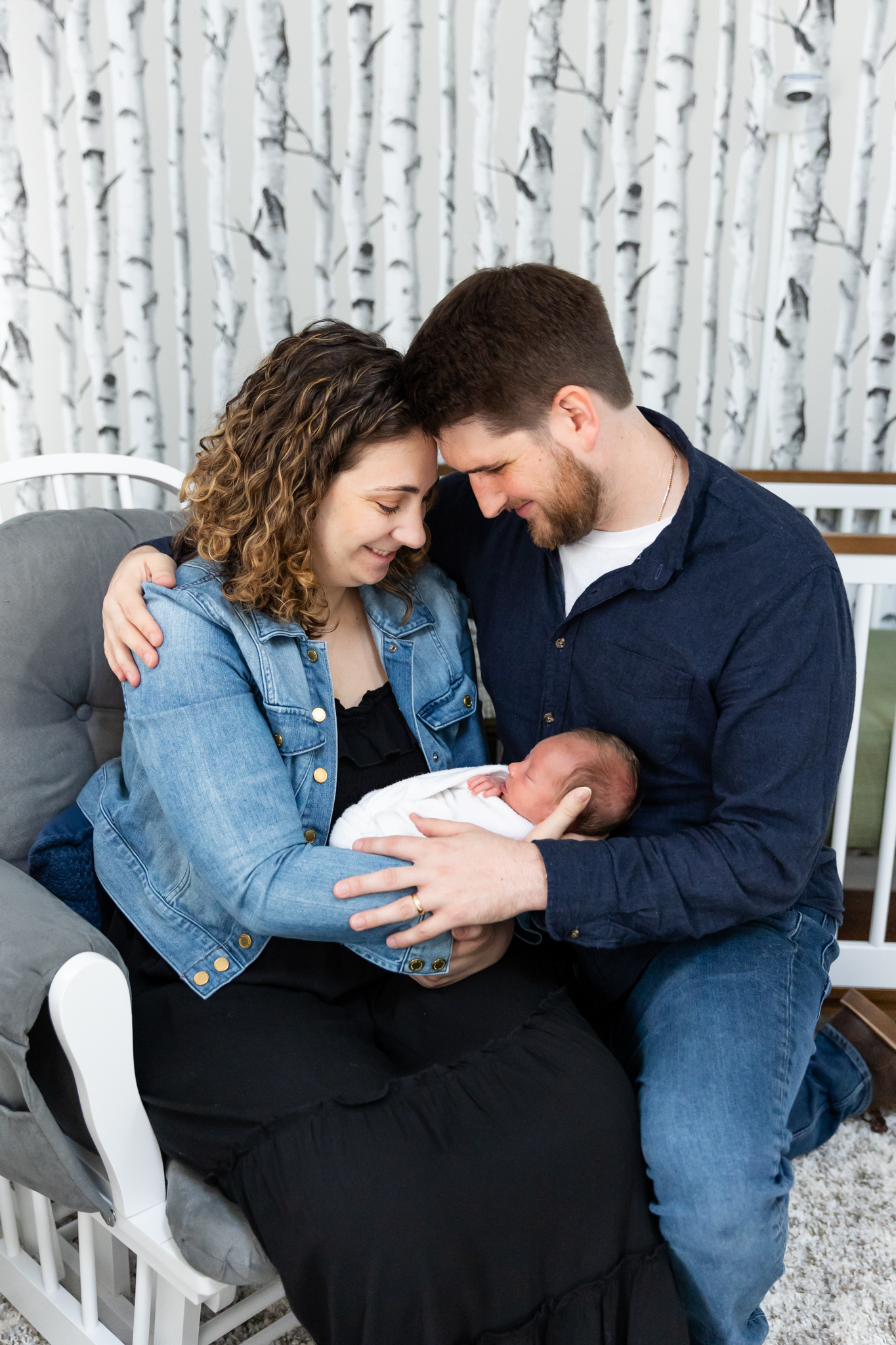 This is a picture of a husband and wife holding their new born baby.