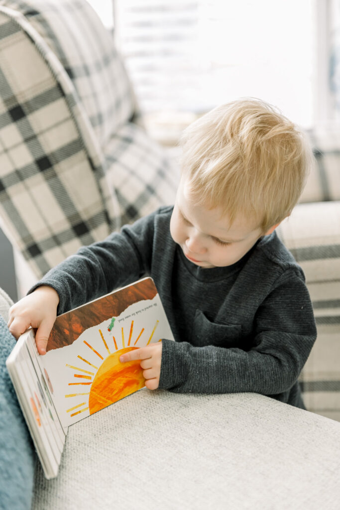 Toddle involved in session by pointing to pages in a book