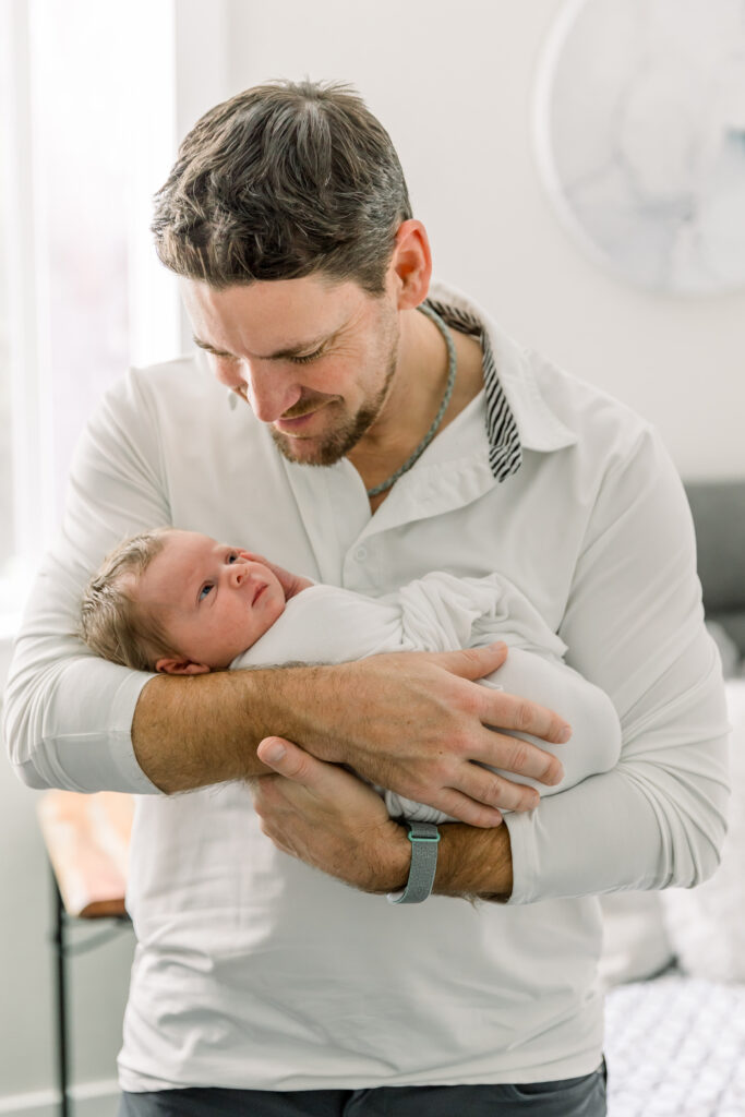 Dad holding baby from newborn session