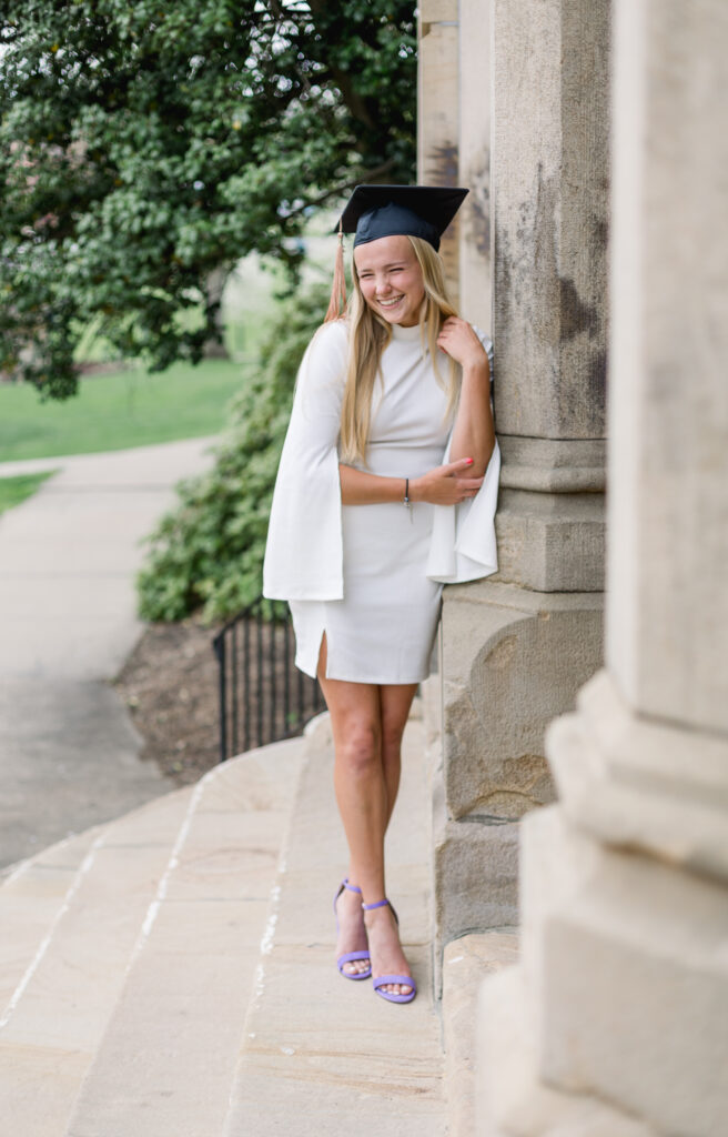 College graduate wearing a black cap and white dress  