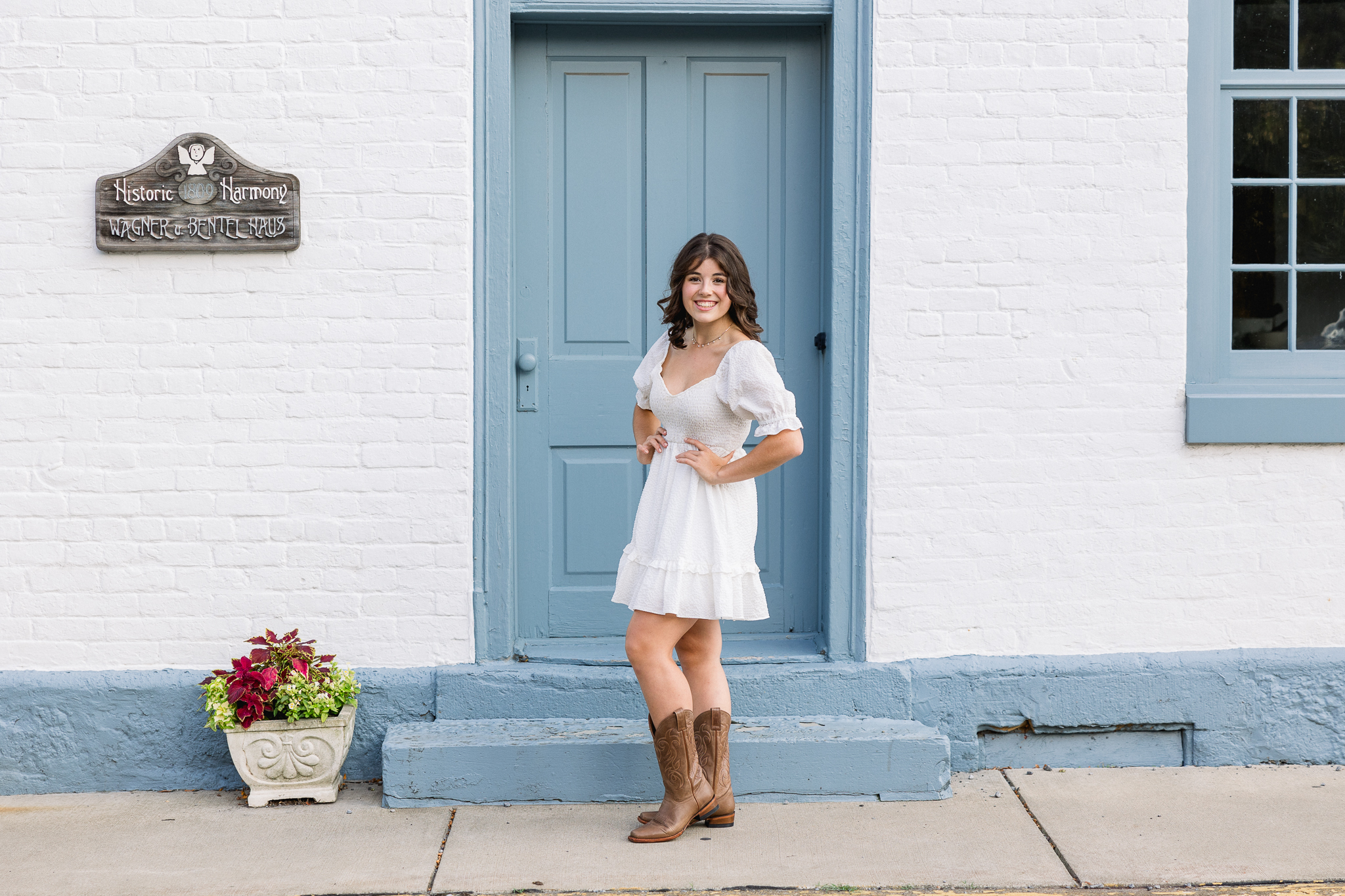 Senior girl standing in front of historic building in Harmony PA