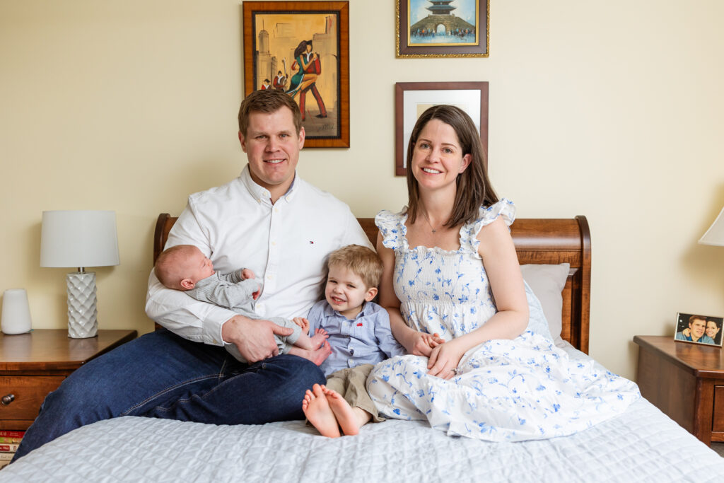 Family wearing neutral clothing for in home newborn session