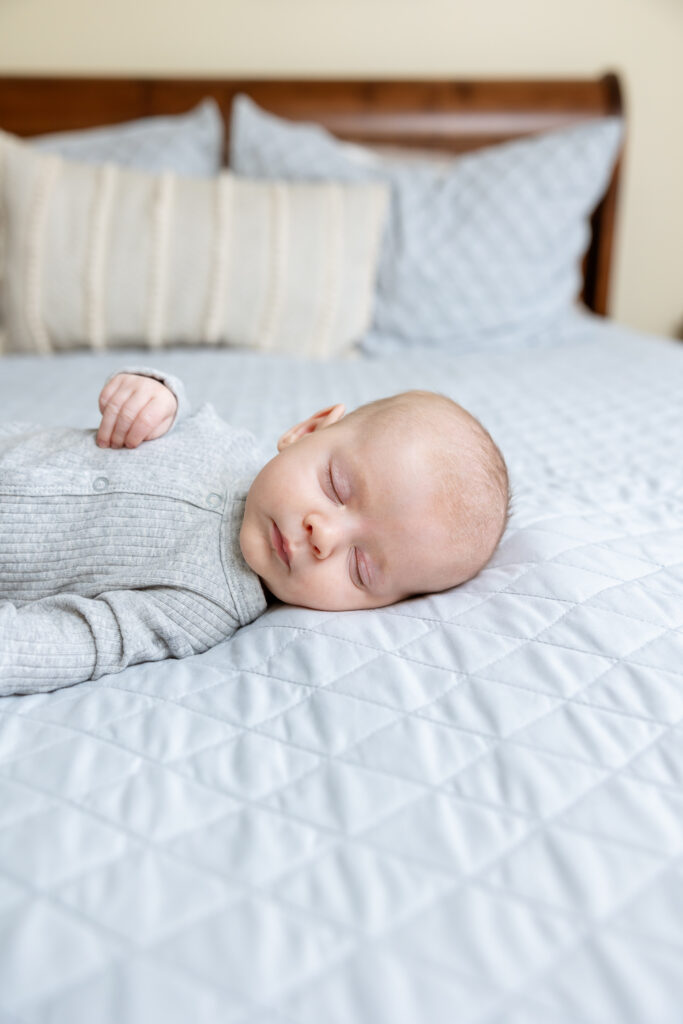 Newborn sleeping on primary bed