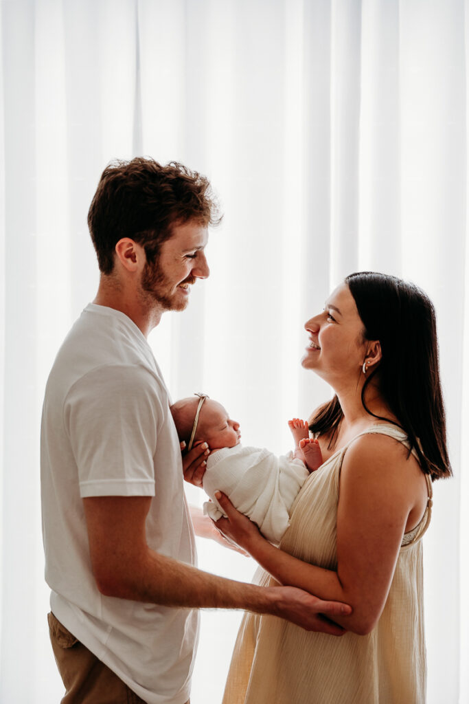 Marie Koleka photo of a newborn and parents in her home studio environment