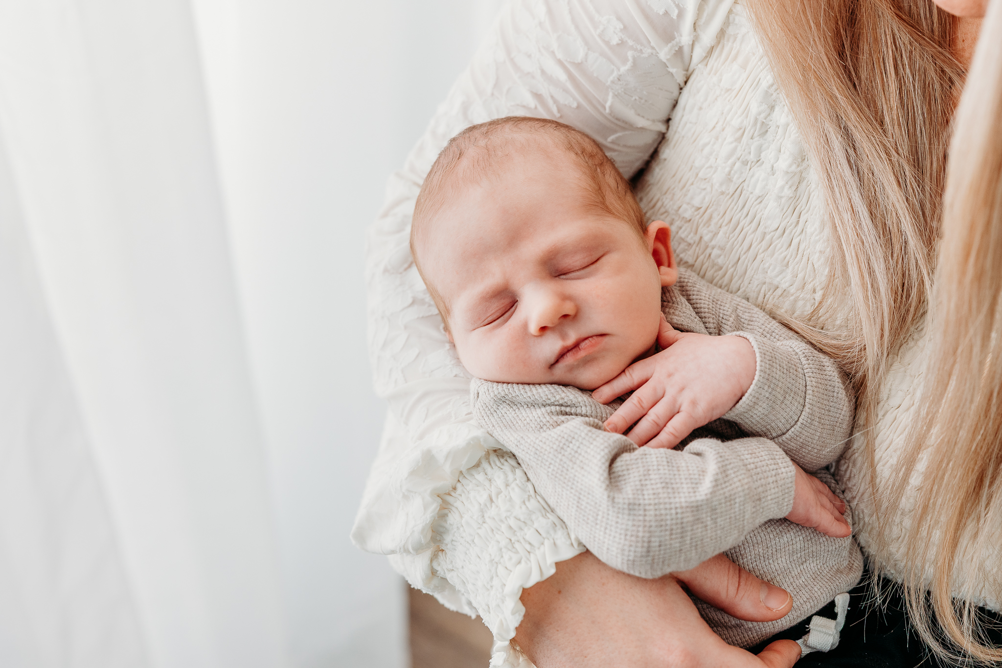 Parents holding newborn in a photography studio in Beaver PA
